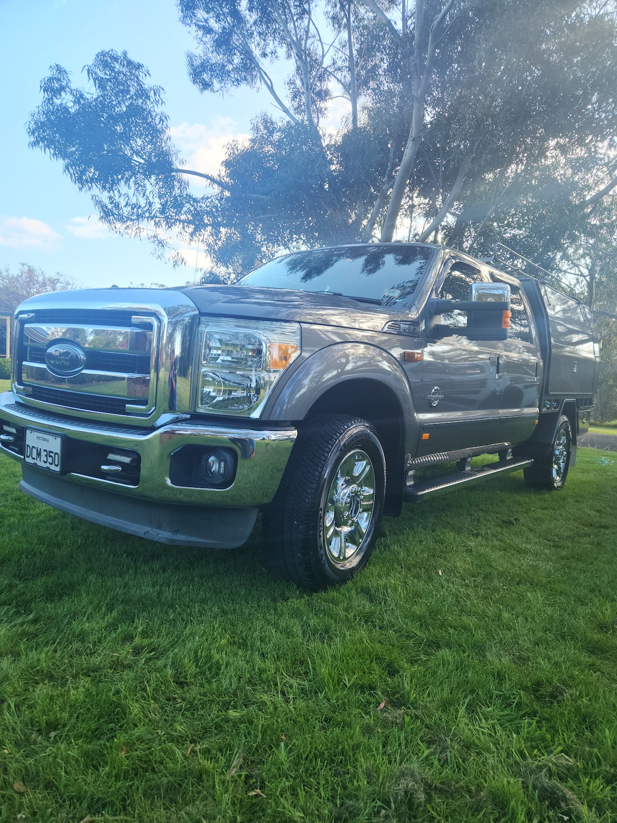 Ford F-250 tray back ute detailed and parked on grass