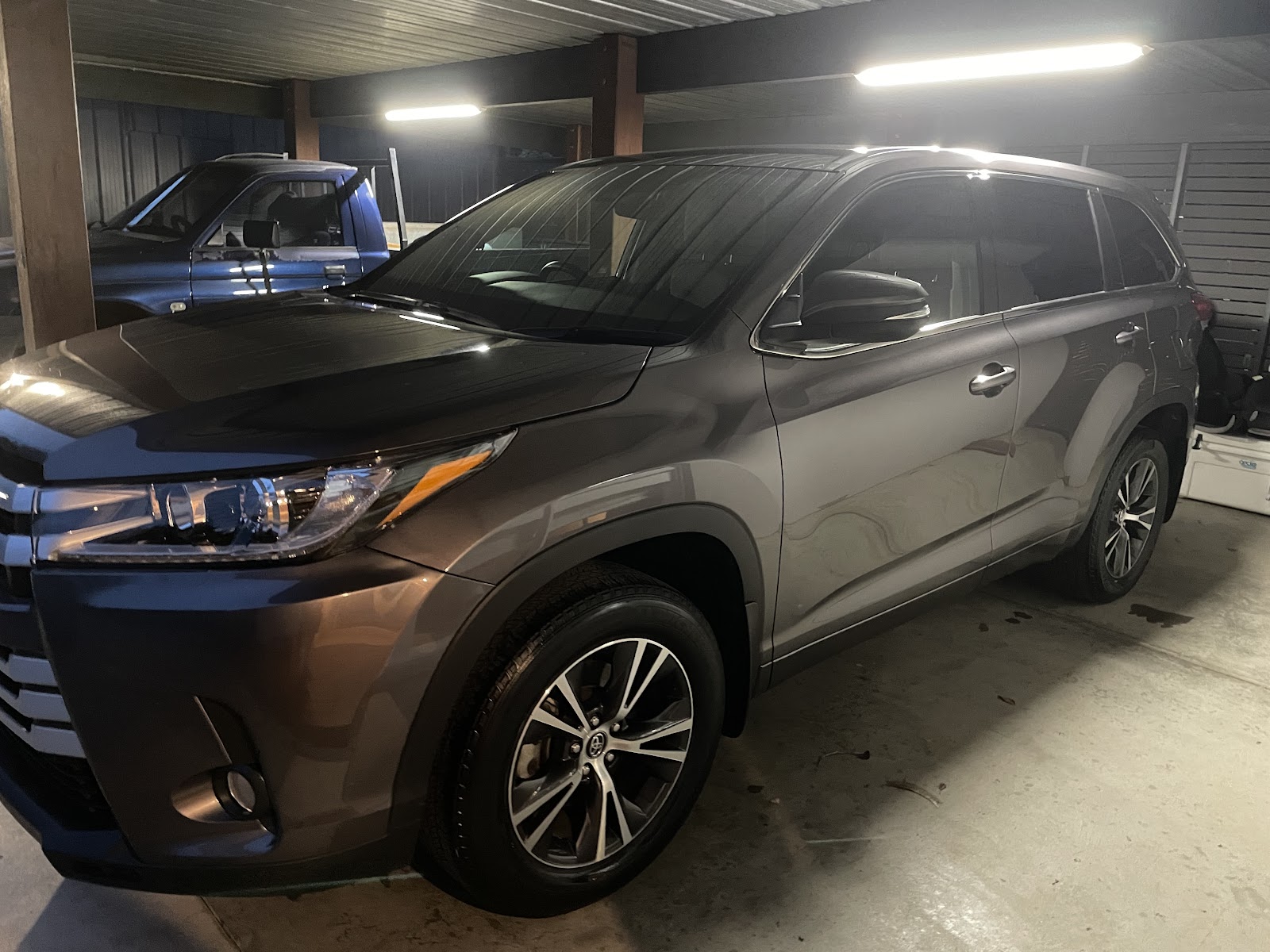 Toyota Kluger gleaming under shed lighting