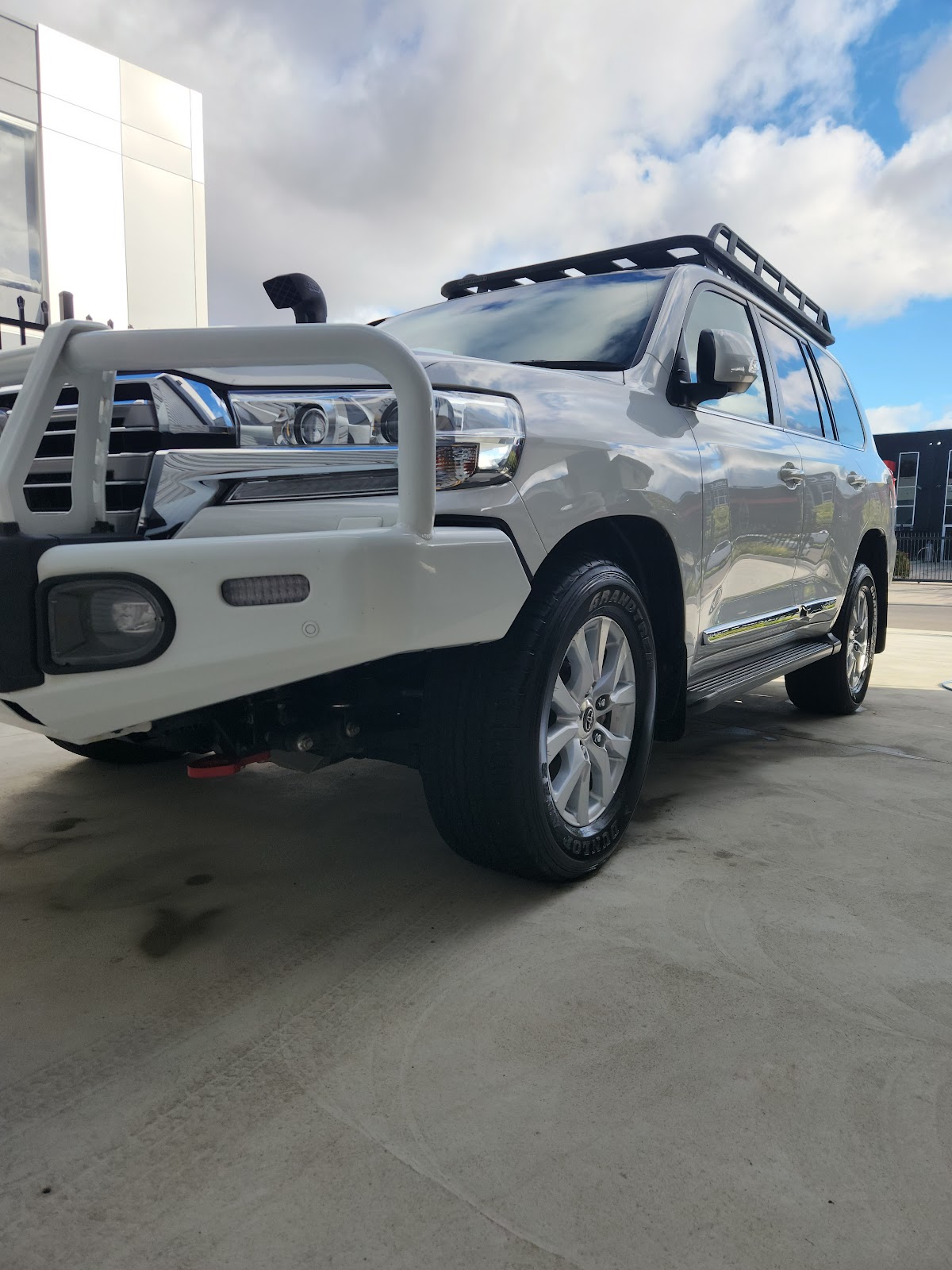 White Toyota LandCruiser with bullbar, freshly detailed
